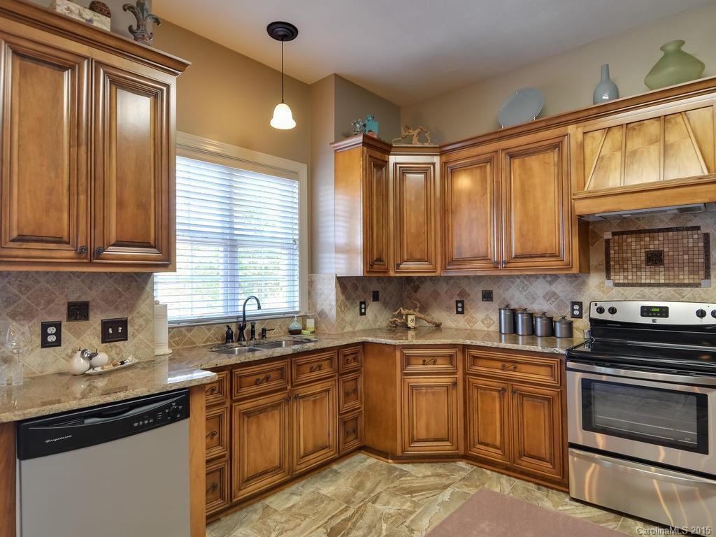 275 Whippoorwill Road Mooresville, NC 28117 - Photo 3 of 24 a kitchen with stainless steel appliances granite countertop a sink stove and cabinets