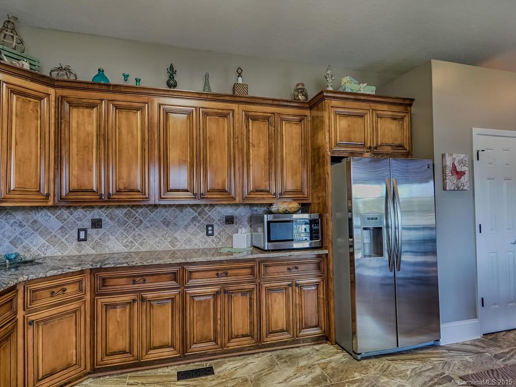 275 Whippoorwill Road Mooresville, NC 28117 - Photo 4 of 24 a kitchen with stainless steel appliances granite countertop a refrigerator and a sink