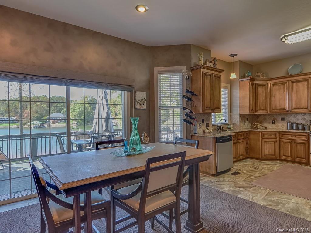 275 Whippoorwill Road Mooresville, NC 28117 - Photo 5 of 24 a dining room with a table chairs and kitchen view