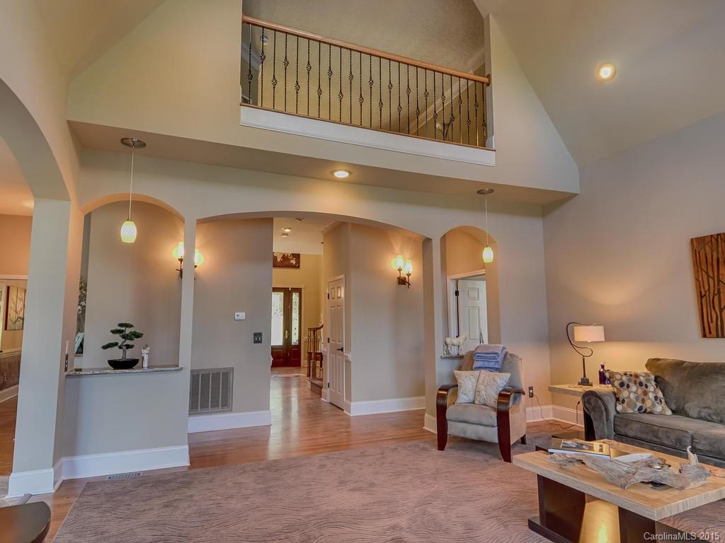 275 Whippoorwill Road Mooresville, NC 28117 - Photo 6 of 24 a living room with furniture a rug and a chandelier