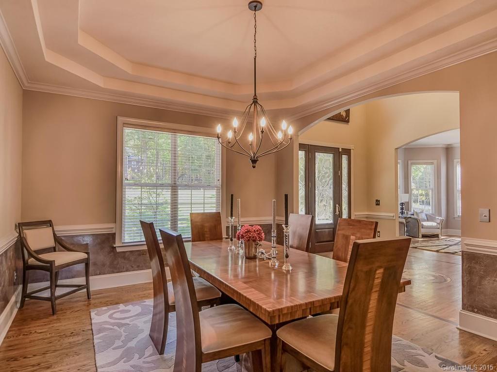 275 Whippoorwill Road Mooresville, NC 28117 - Photo 8 of 24 a dining room with furniture a chandelier and wooden floor