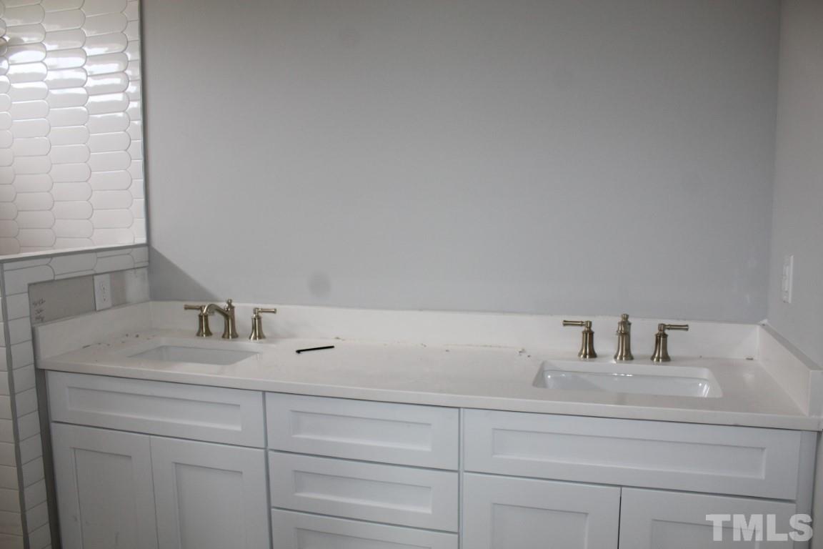 328 Prides Crossing Rolesville, NC 27571 - Photo 11 of 23 a bathroom with a sink and a mirror
