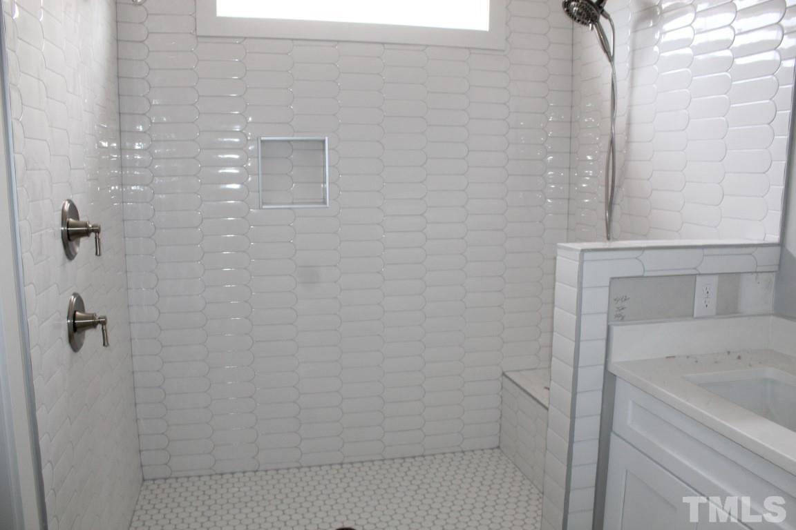328 Prides Crossing Rolesville, NC 27571 - Photo 12 of 23 a bathroom with a bathtub