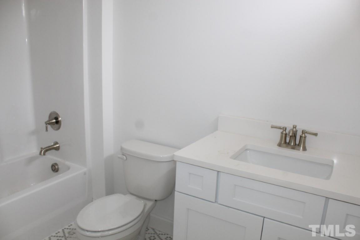 328 Prides Crossing Rolesville, NC 27571 - Photo 14 of 23 a white toilet sitting next to a bath tub