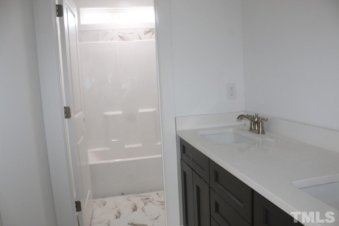 328 Prides Crossing Rolesville, NC 27571 - Photo 18 of 23 a bathroom with a sink and a shower