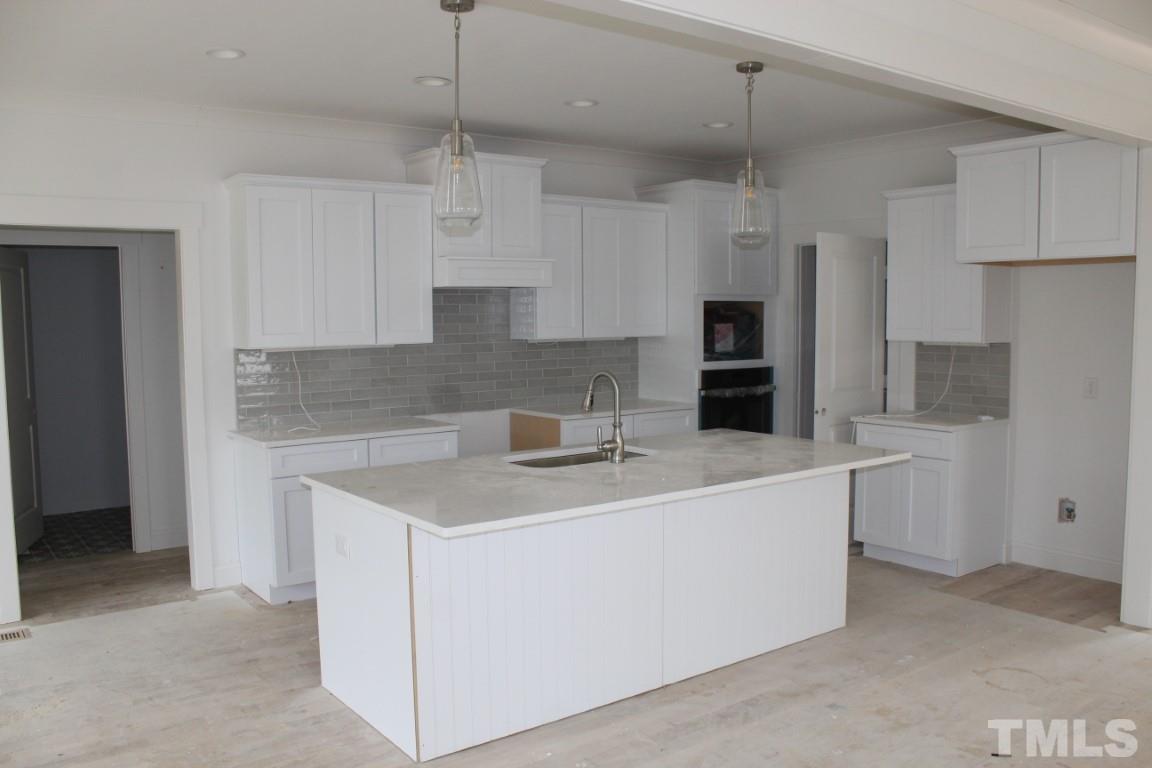 328 Prides Crossing Rolesville, NC 27571 - Photo 3 of 23 a view of a kitchen with cabinets