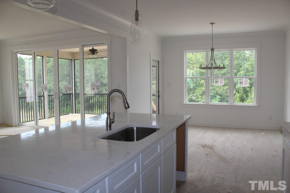 328 Prides Crossing Rolesville, NC 27571 - Photo 4 of 23 a kitchen with a sink and large window