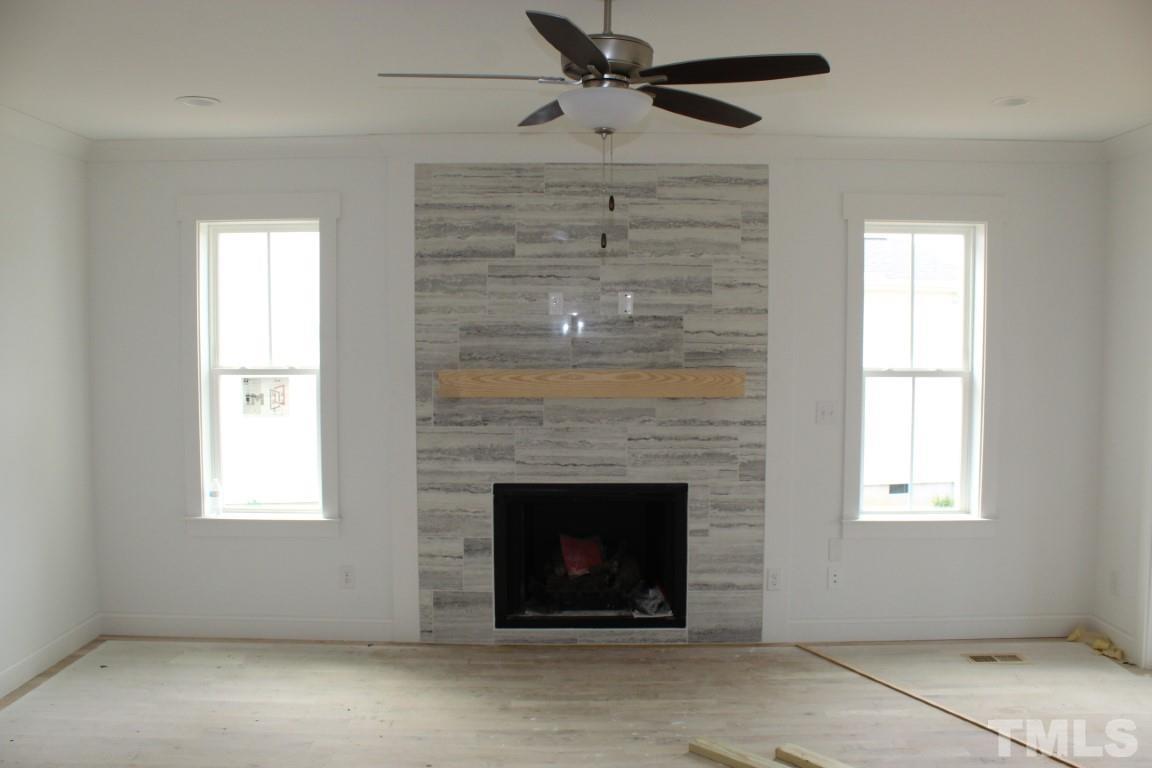 328 Prides Crossing Rolesville, NC 27571 - Photo 5 of 23 an empty room with windows and a fireplace