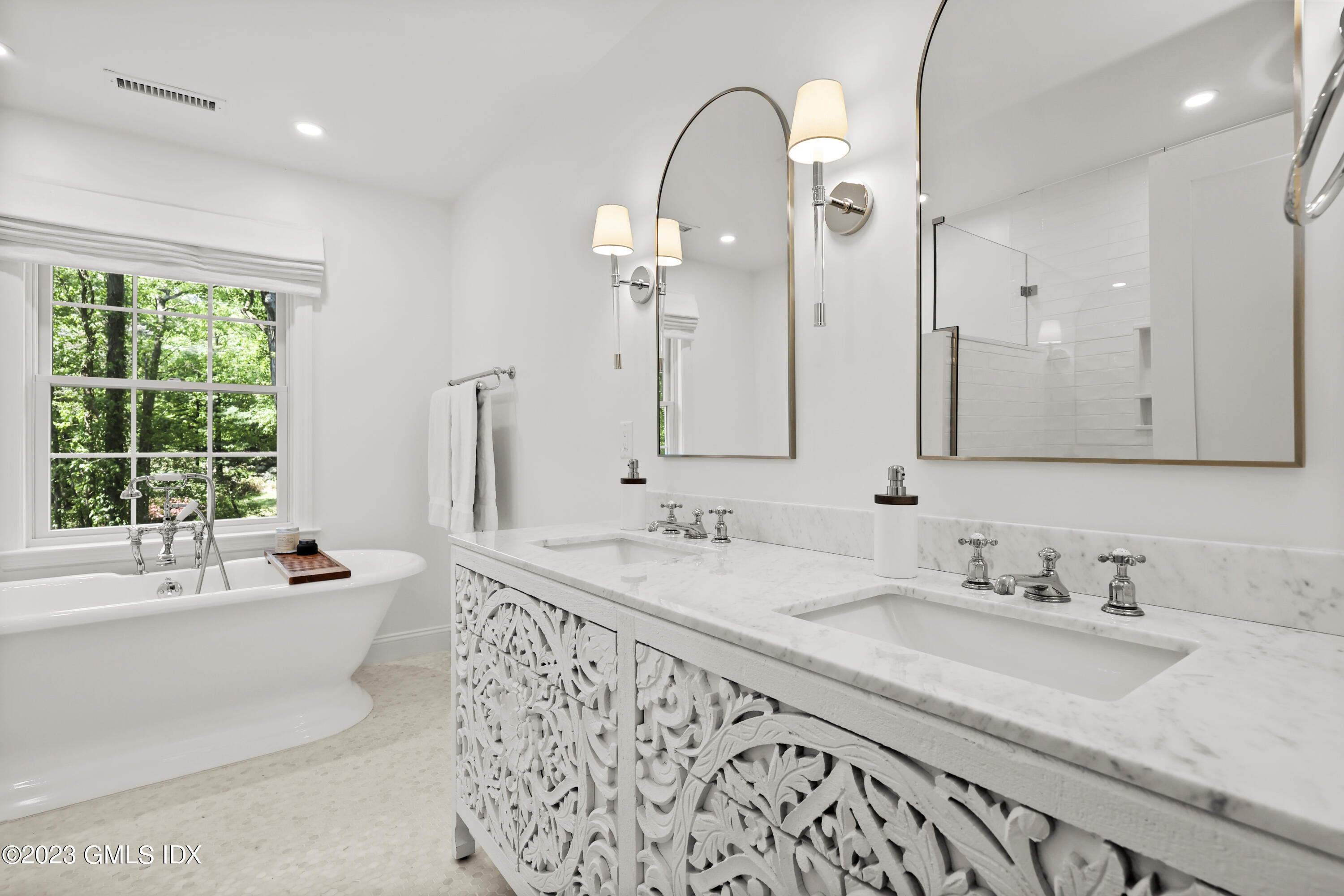 7 Cottontail Road Cos Cob, CT 06807 - Photo 14 of 29 a bathroom with a granite countertop sink a large mirror and a bathtub next to a window