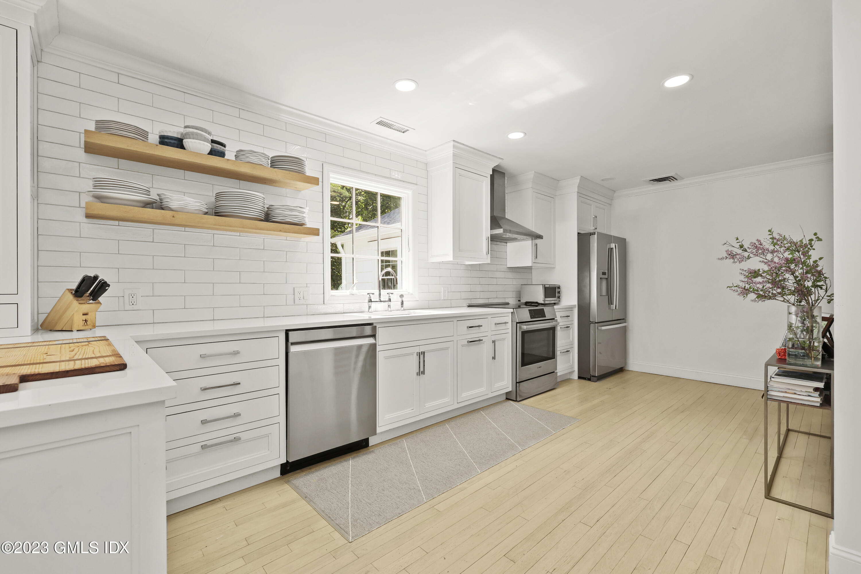 7 Cottontail Road Cos Cob, CT 06807 - Photo 7 of 29 a kitchen with white cabinets stainless steel appliances and sink