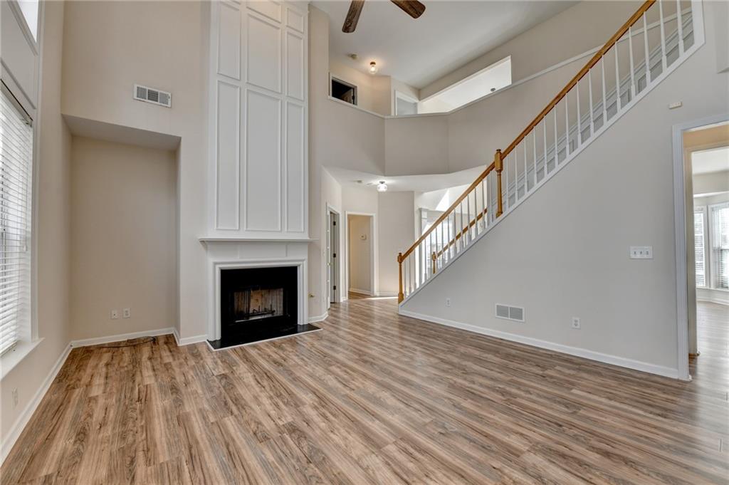 100 Hawnley Trc Northwest Suwanee, GA 30024 - Photo 18 of 58 a view of a livingroom with wooden floor and a fireplace