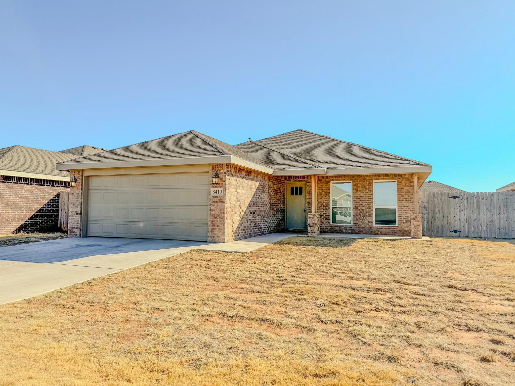 8419 10th Place Lubbock, TX 79416 - Photo 1 of 11 a front view of a house with a yard