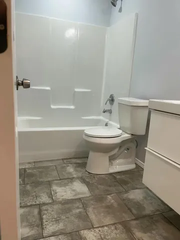 a bathroom with a toilet a sink and bathtub