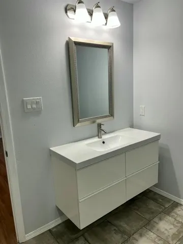 a bathroom with a sink and a mirror