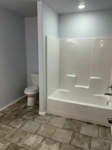 a bathroom with a bathtub and a toilet
