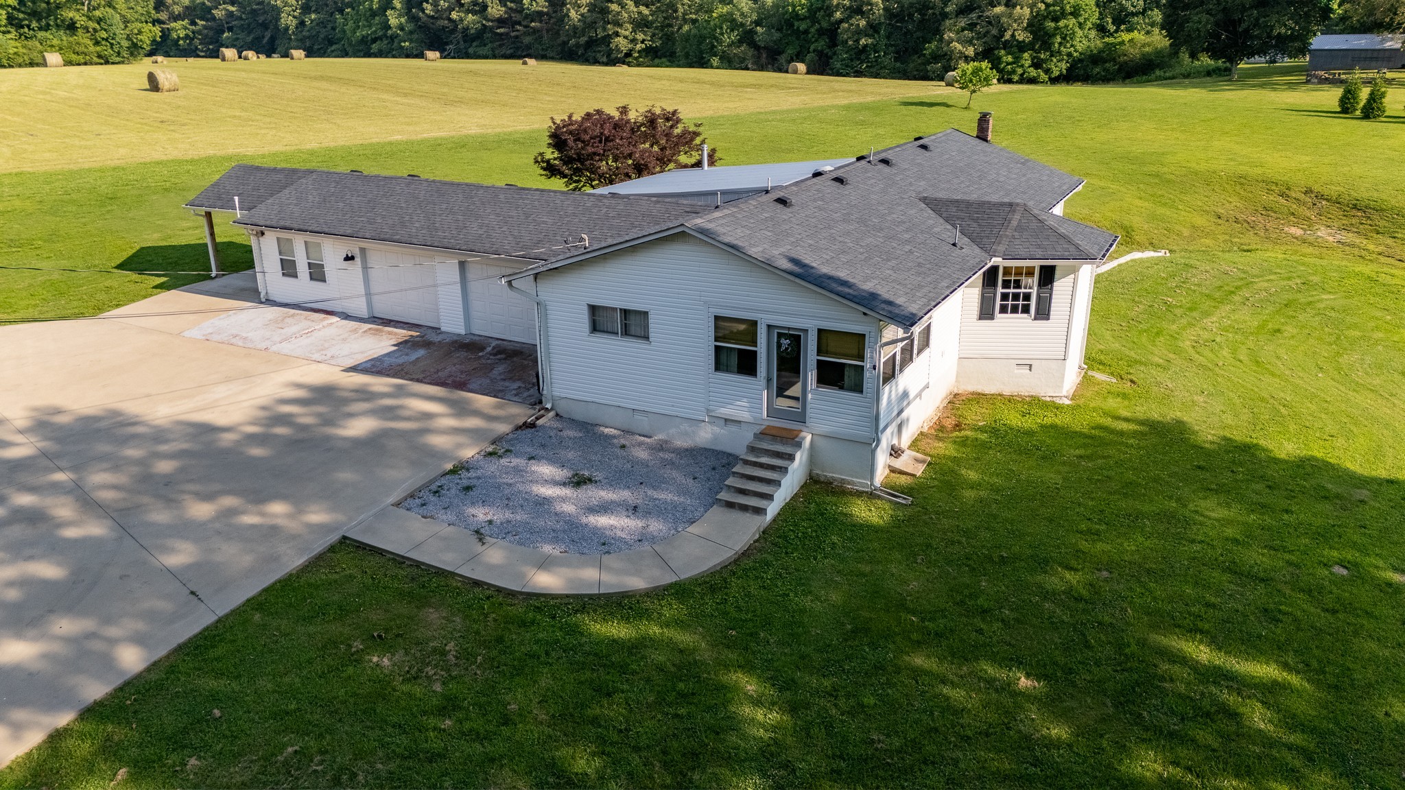 an aerial view of a house with a yard and lake view