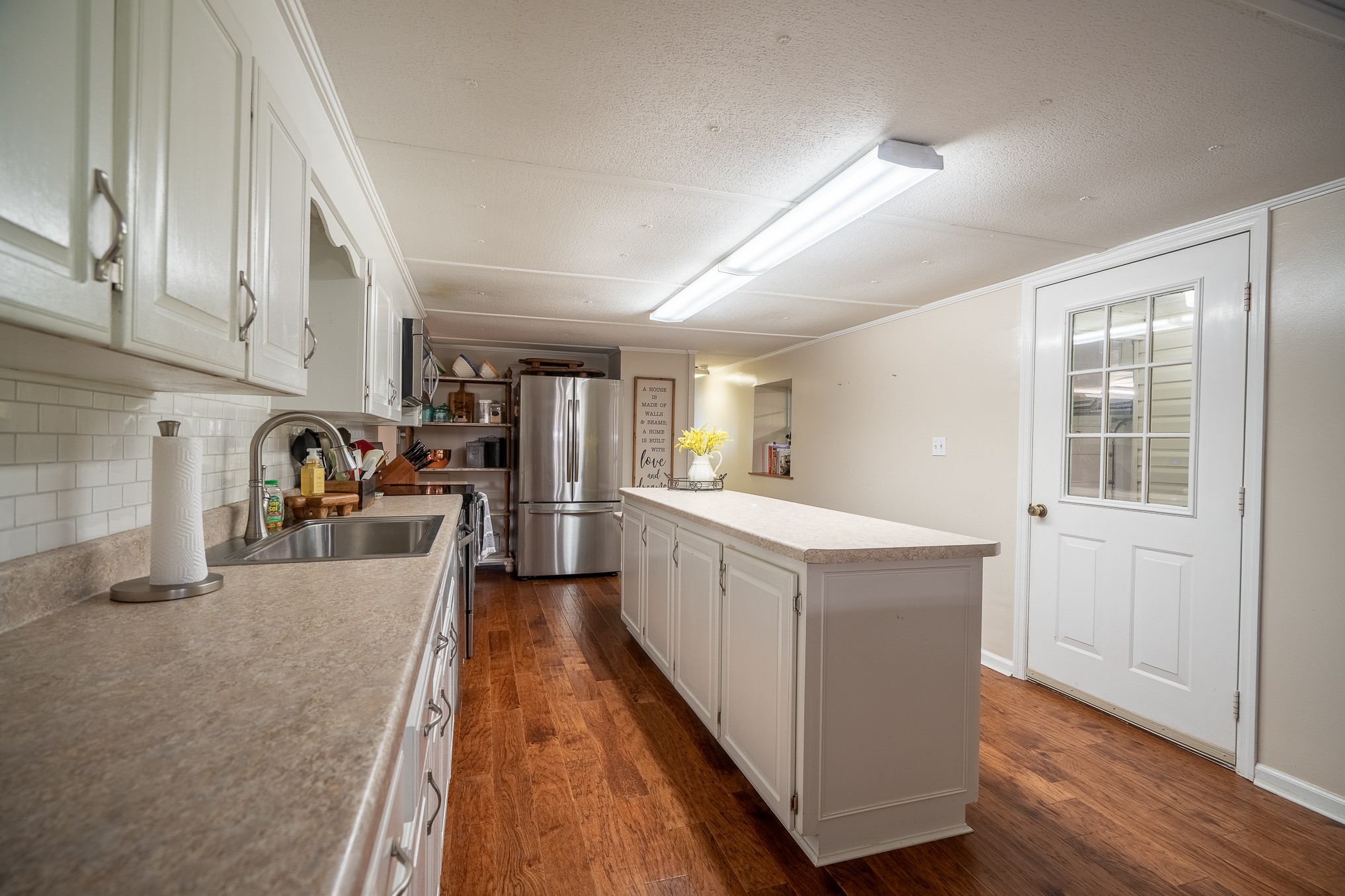 876 West Point Road Lawrenceburg, TN 38464 - Photo 20 of 42 a kitchen with cabinets and wooden floor