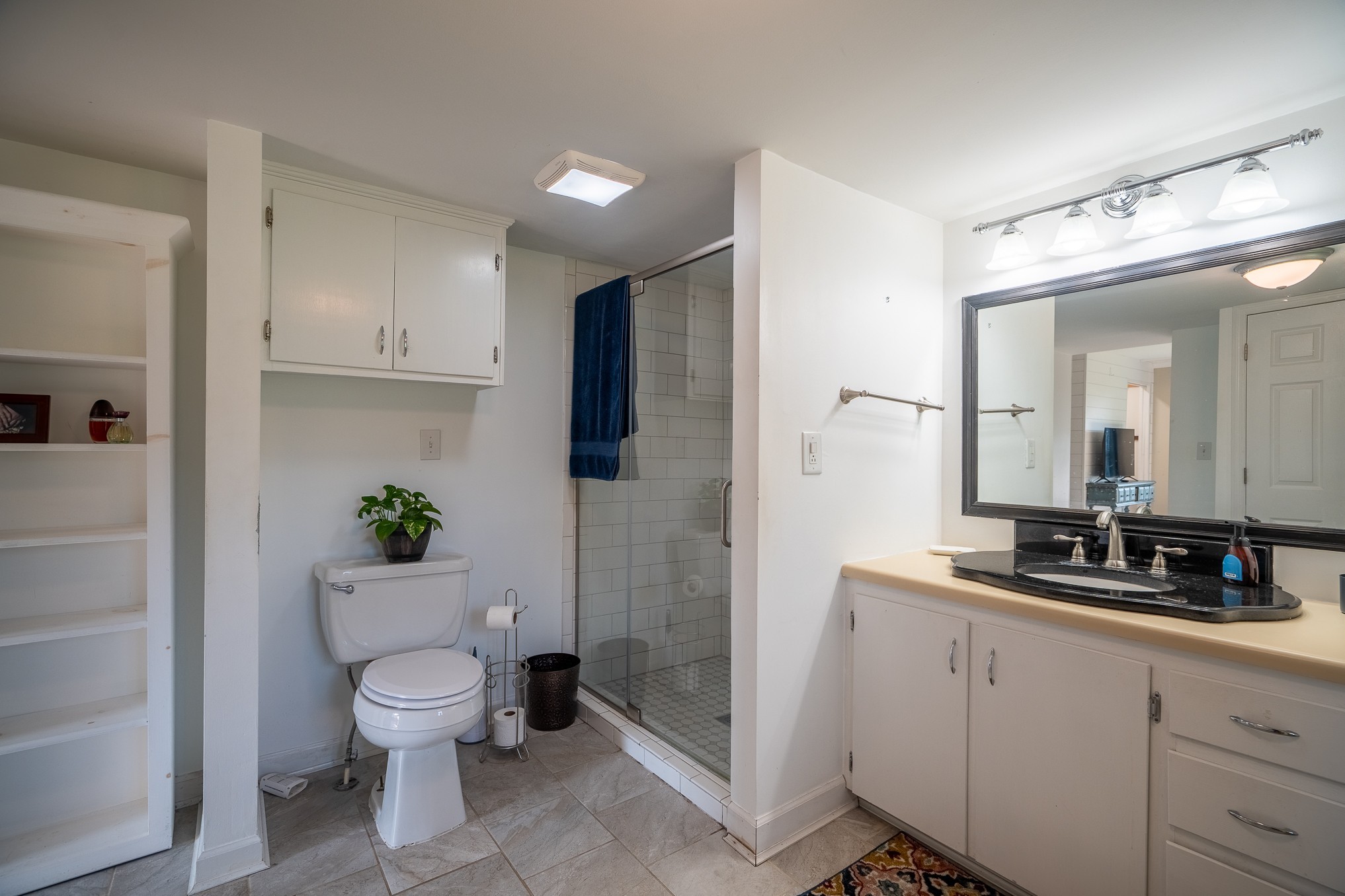 876 West Point Road Lawrenceburg, TN 38464 - Photo 24 of 42 a spacious bathroom with a granite countertop sink a toilet a mirror and shower