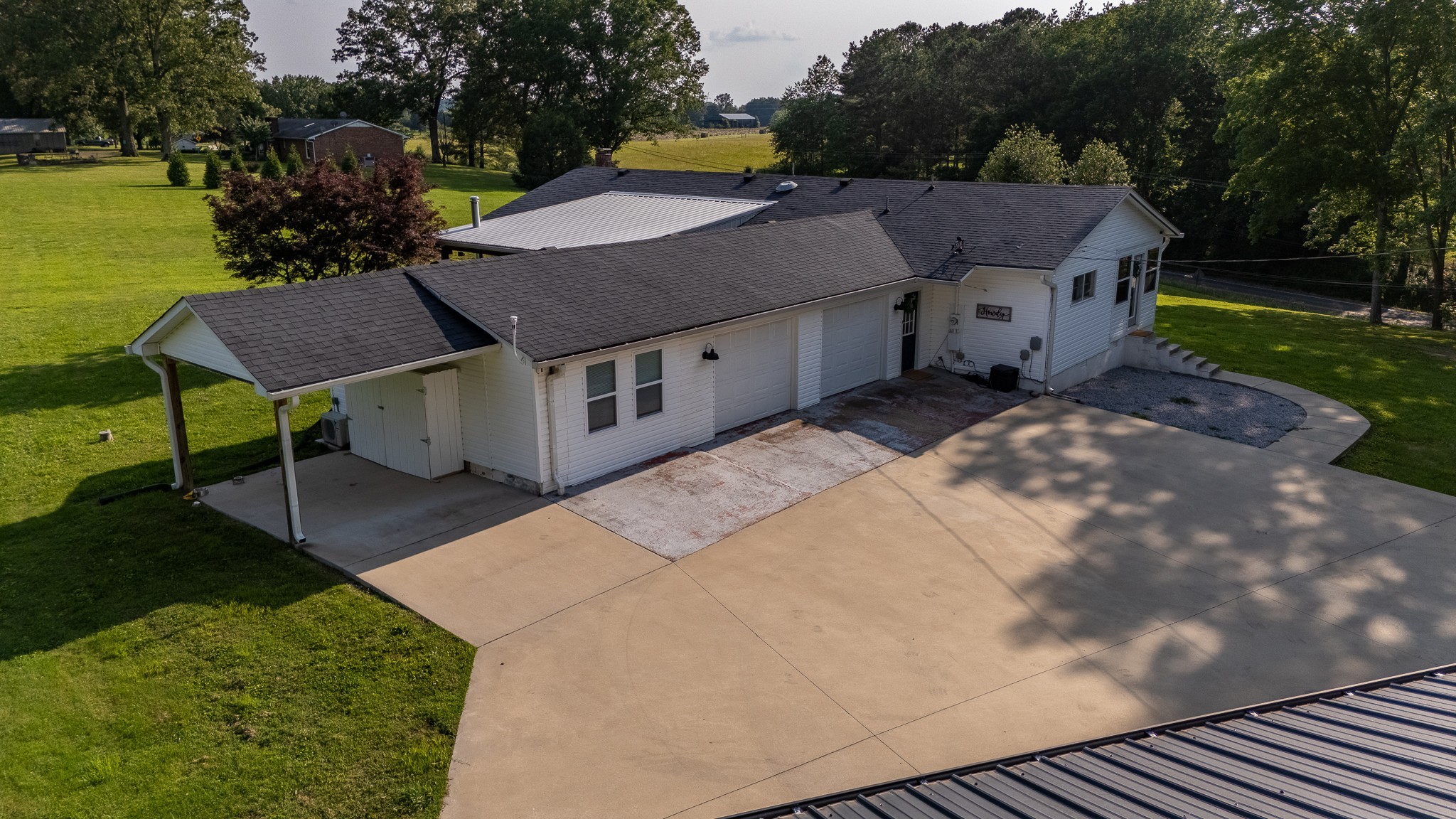 876 West Point Road Lawrenceburg, TN 38464 - Photo 37 of 42 a aerial view of a house with table and chairs under an umbrella
