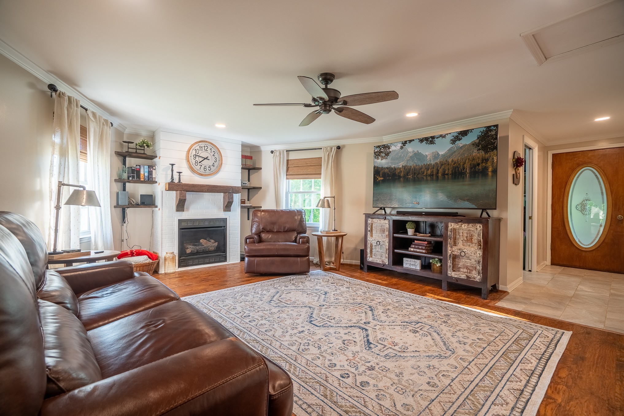 876 West Point Road Lawrenceburg, TN 38464 - Photo 9 of 42 a living room with furniture a flat screen tv and a fireplace