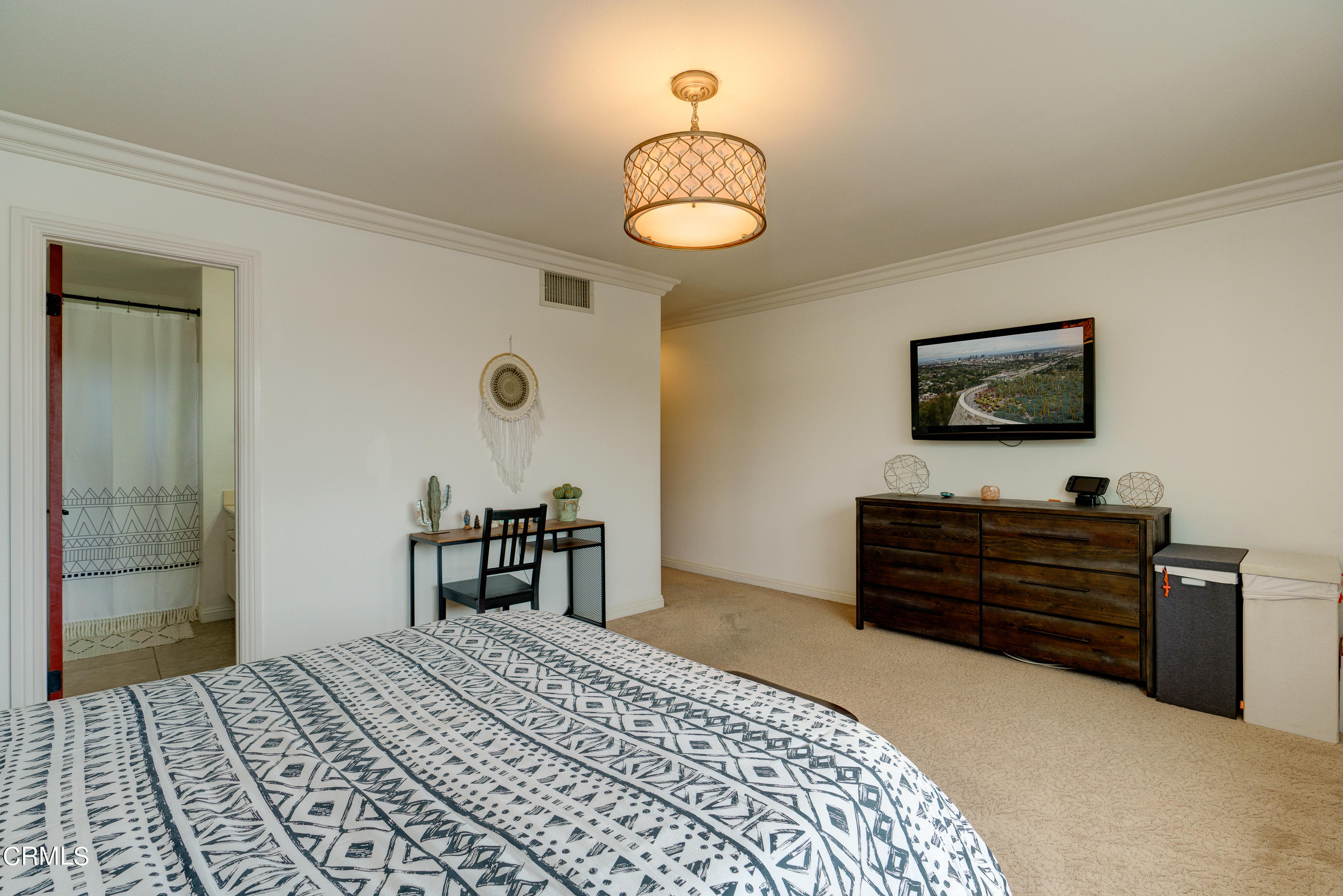 1102 Calle Adra Duarte, CA 91010 - Photo 27 of 30 a bedroom with a bed and a chandelier