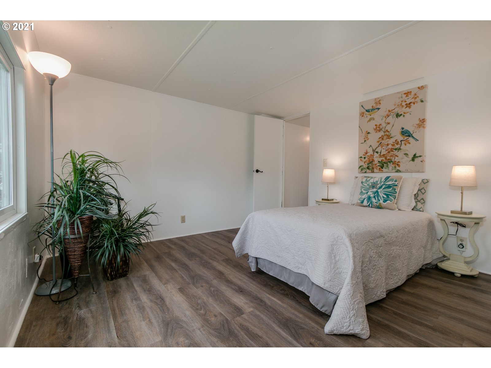 7080 Thurston Road, Unit SP 12 Springfield, OR 97478 - Photo 15 of 22 a bedroom with a bed and a potted plant