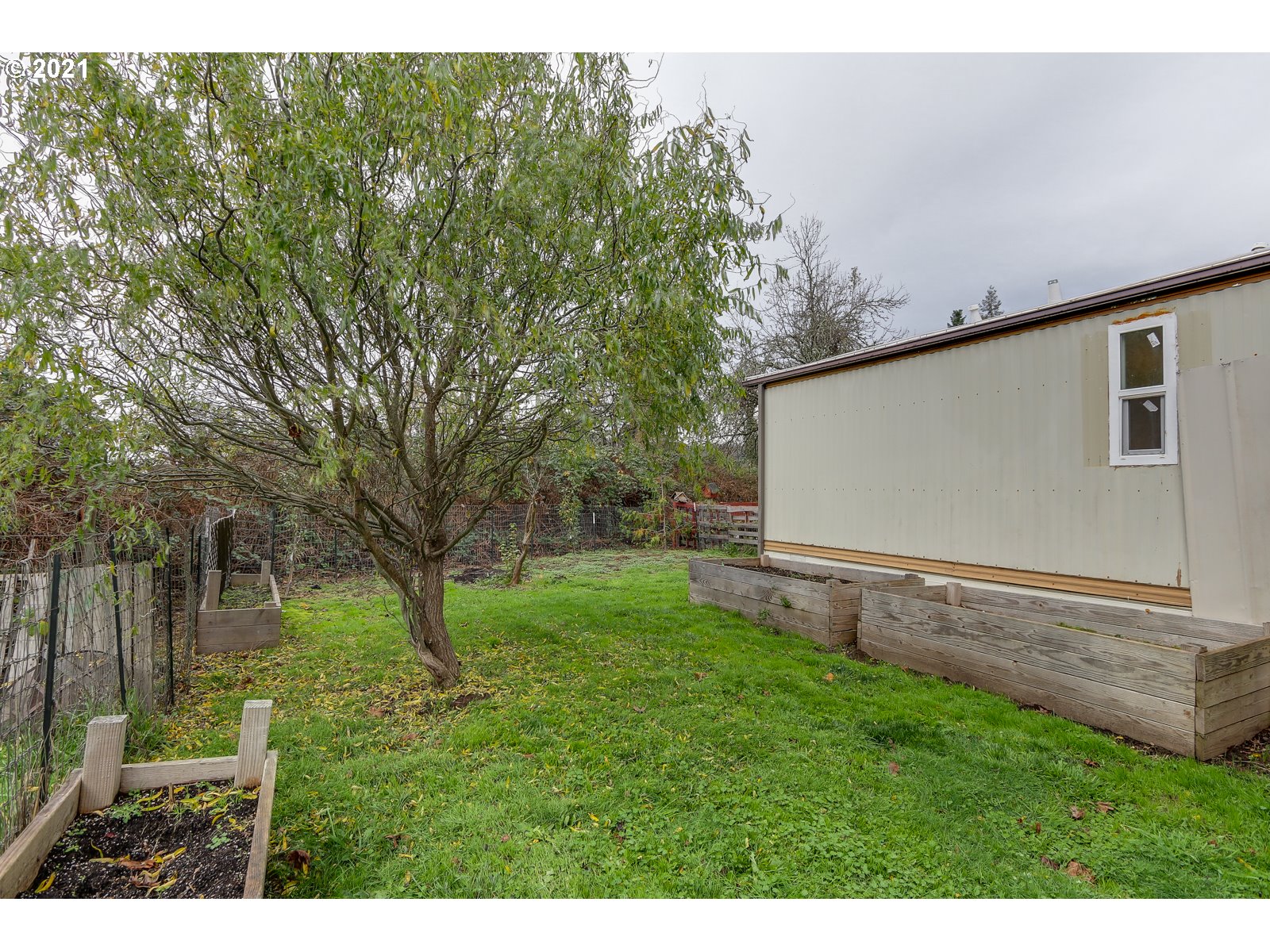 7080 Thurston Road, Unit SP 12 Springfield, OR 97478 - Photo 19 of 22 a backyard of a house with lots of green space