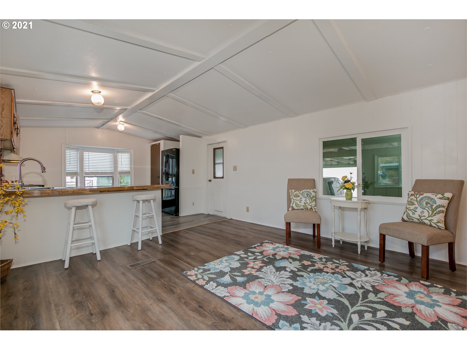 7080 Thurston Road, Unit SP 12 Springfield, OR 97478 - Photo 8 of 22 a view of kitchen and dining room with wooden floor