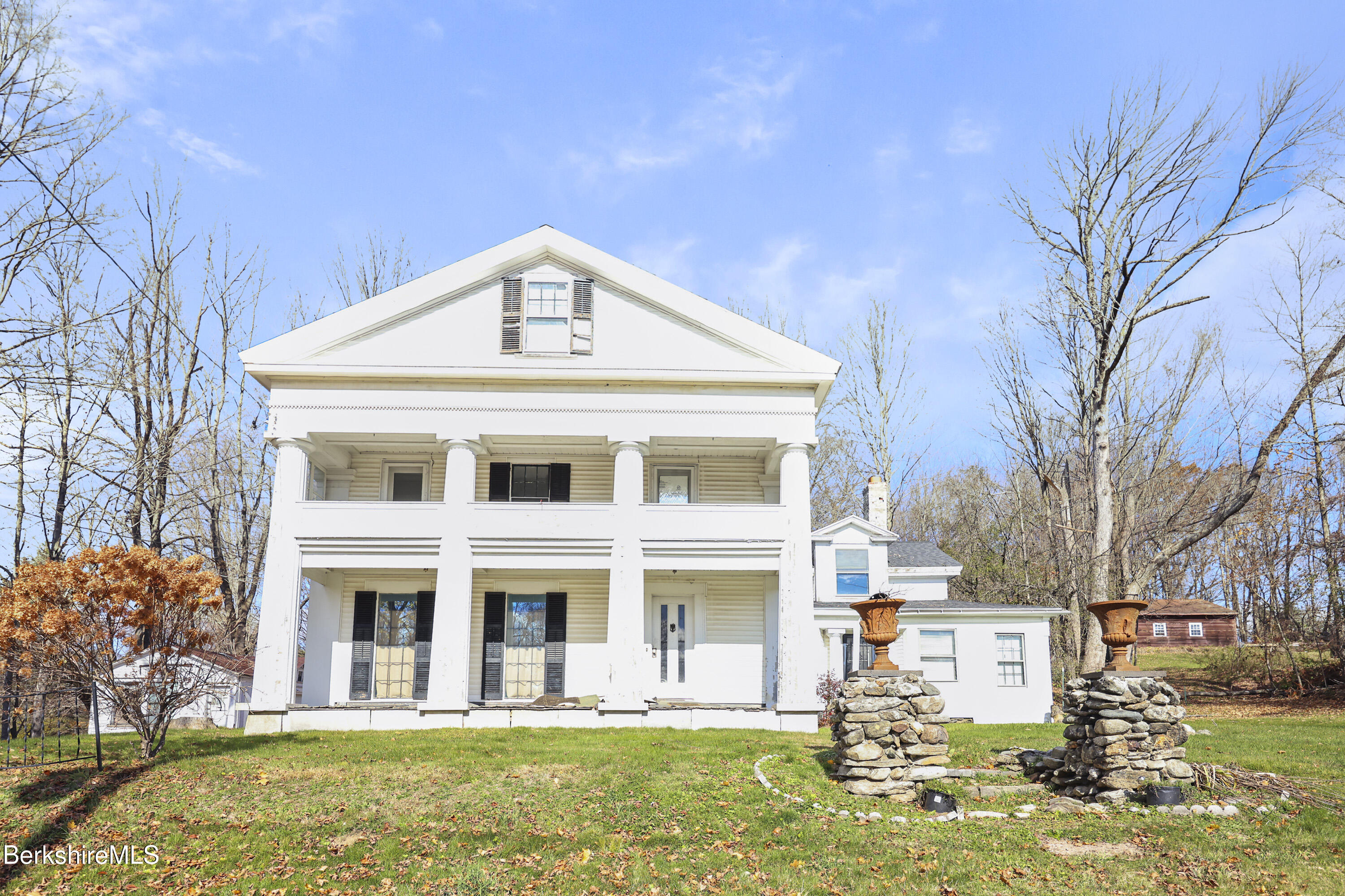 469 Maple Street Hinsdale, MA 01235 - Photo 1 of 14 a front view of a residential apartment building with a yard