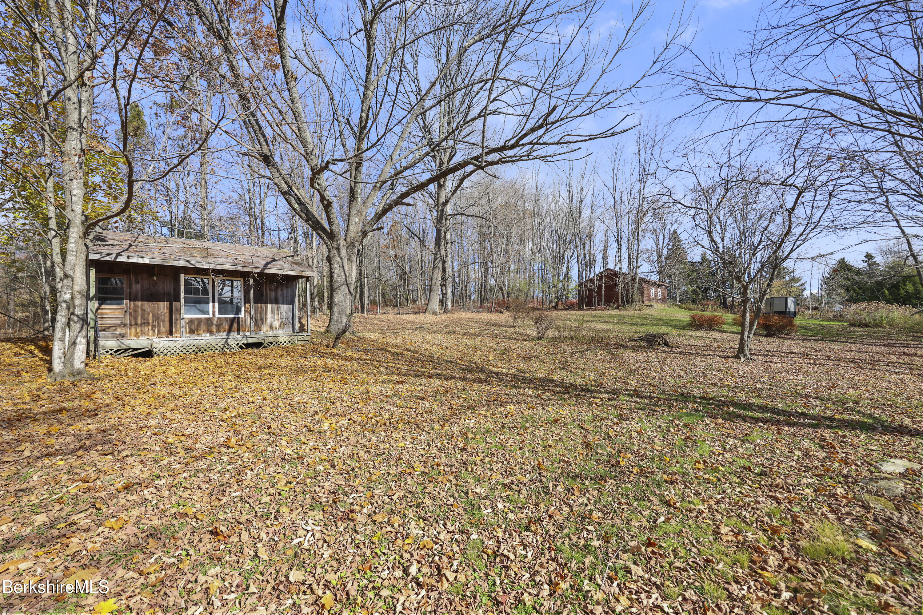 469 Maple Street Hinsdale, MA 01235 - Photo 12 of 14 a backyard of a house with large trees and outdoor seating