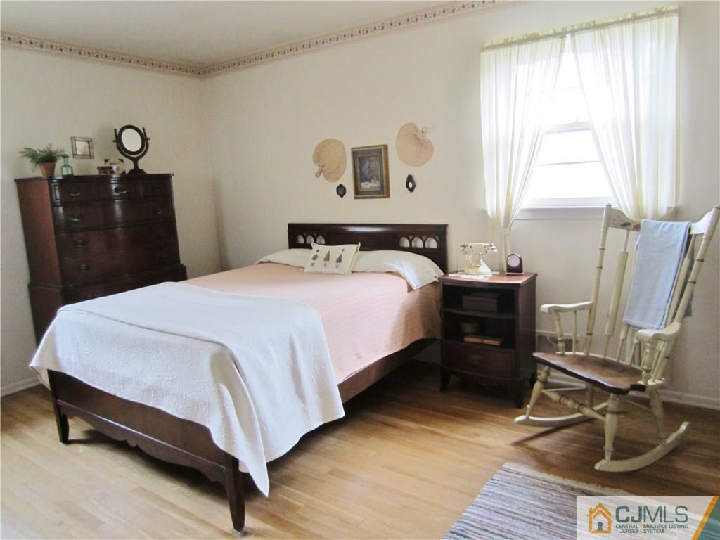 35 Monaghan Road Edison, NJ 08817 - Photo 14 of 25 a bedroom with a bed and wooden floor