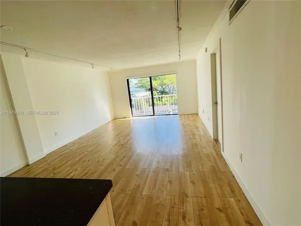 a view of interior space and wooden floor