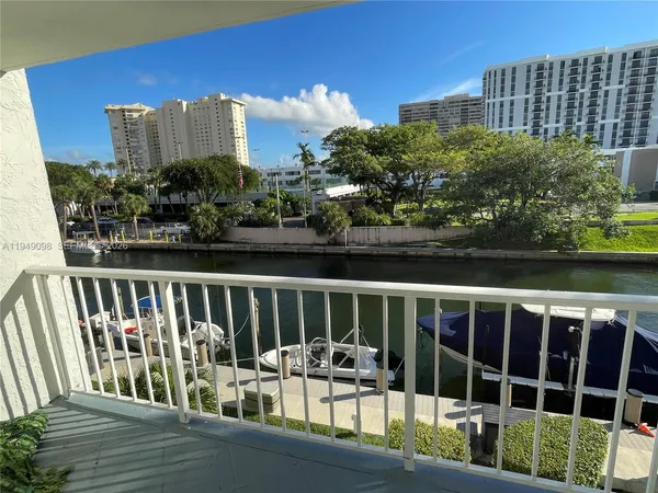 a view of roof deck with chairs and wooden fence