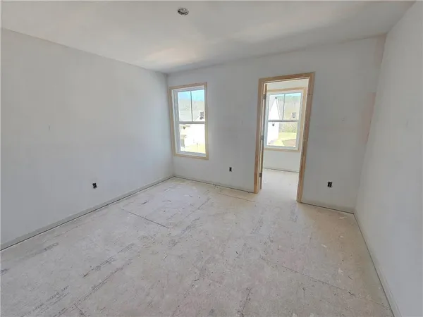 a view of an empty room with windows