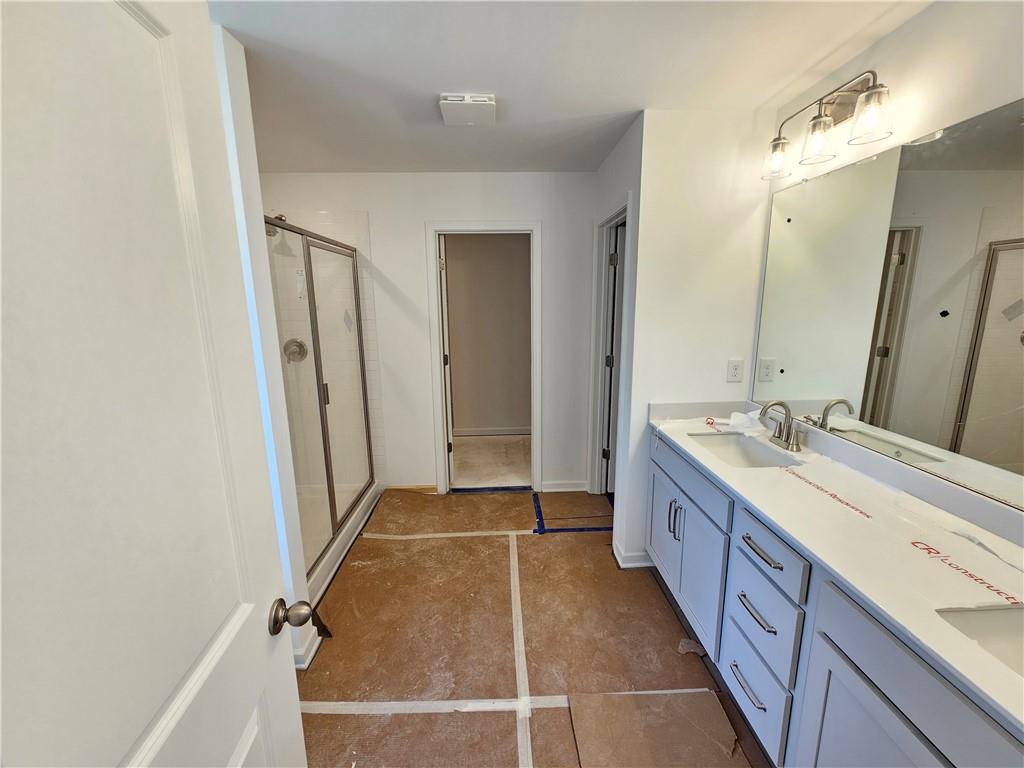 120 Silverleaf Trail Bethlehem, GA 30620 - Photo 17 of 45 a bathroom with a double vanity sink and a mirror