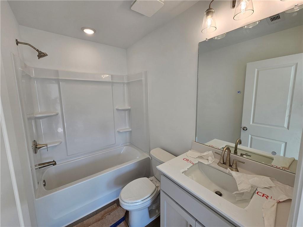 120 Silverleaf Trail Bethlehem, GA 30620 - Photo 23 of 45 a bathroom with a sink toilet and shower