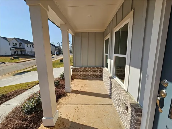 a view of a house with backyard sitting area and porch