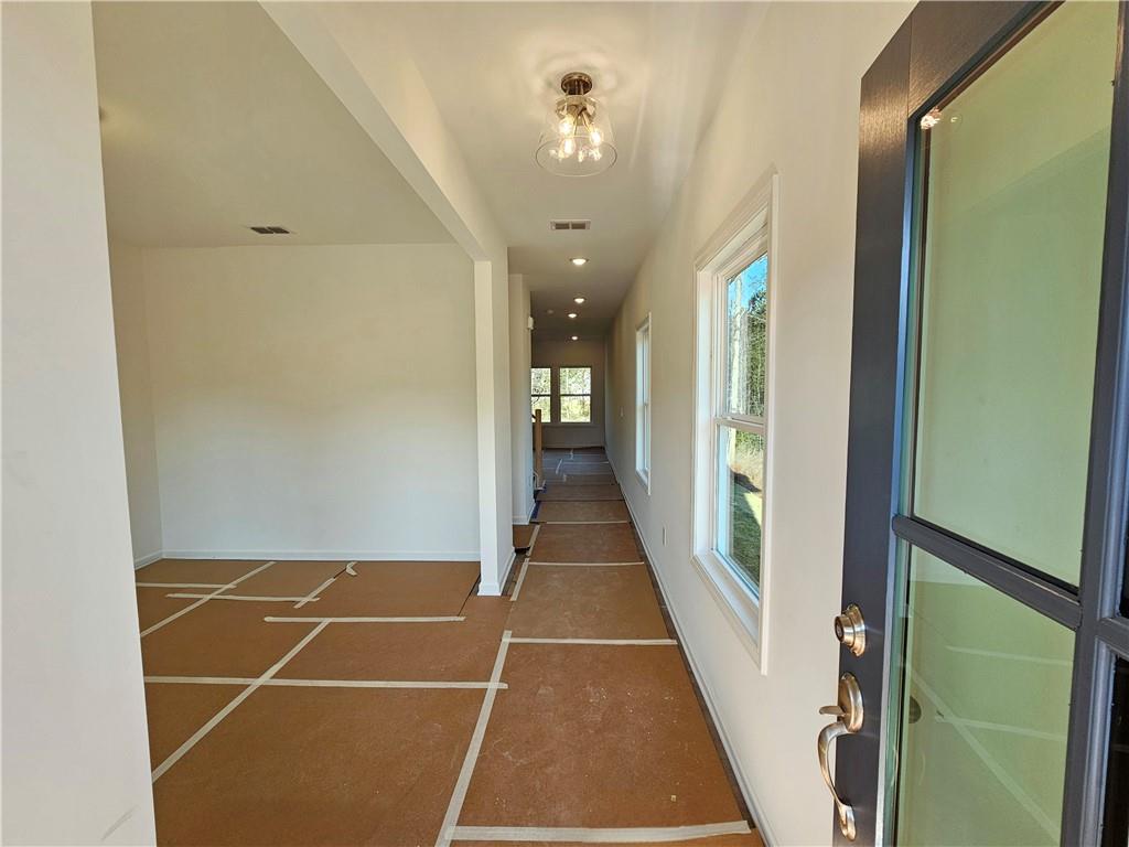 120 Silverleaf Trail Bethlehem, GA 30620 - Photo 7 of 45 a view of a hallway with wooden floor and staircase