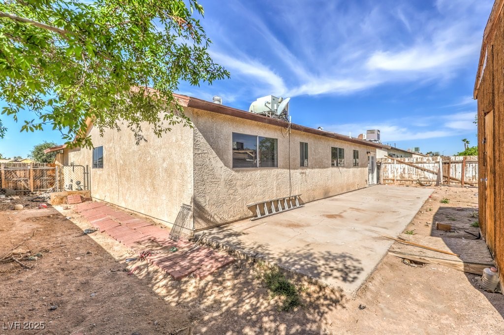 3948 Maple Hill Road Las Vegas, NV 89115 - Photo 18 of 20 Rear view of property with a patio, stucco siding, and fence