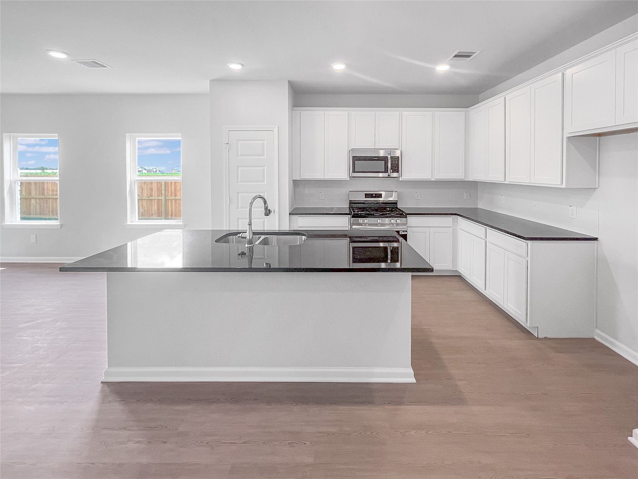 The Waring III- Kitchen with Large Island. Sample image for illustration; upgrades, options, and colors may vary.