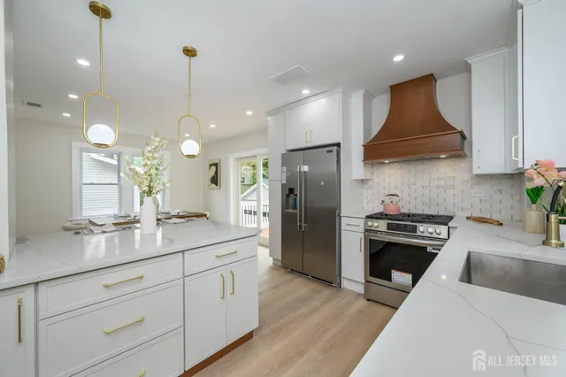 a kitchen with a sink stainless steel appliances and cabinets