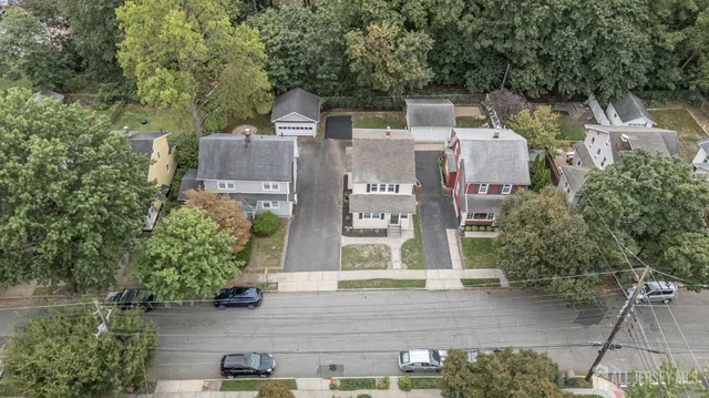 a aerial view of a house with a yard and sitting area