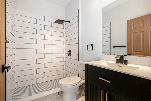 a bathroom with a sink toilet and shower