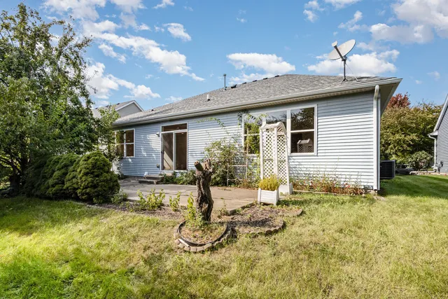 a view of a house with backyard and sitting area