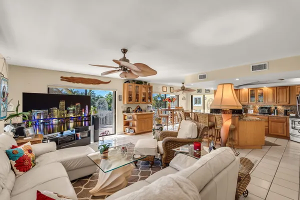 a living room with furniture and a ceiling fan