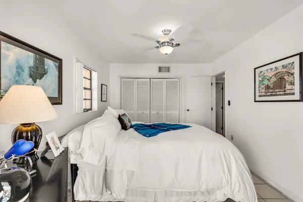 a balcony with furniture and a potted plant