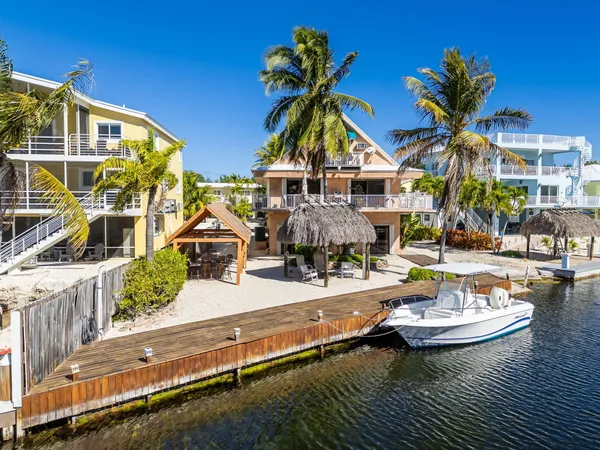 a front view of house with yard swimming pool and outdoor seating