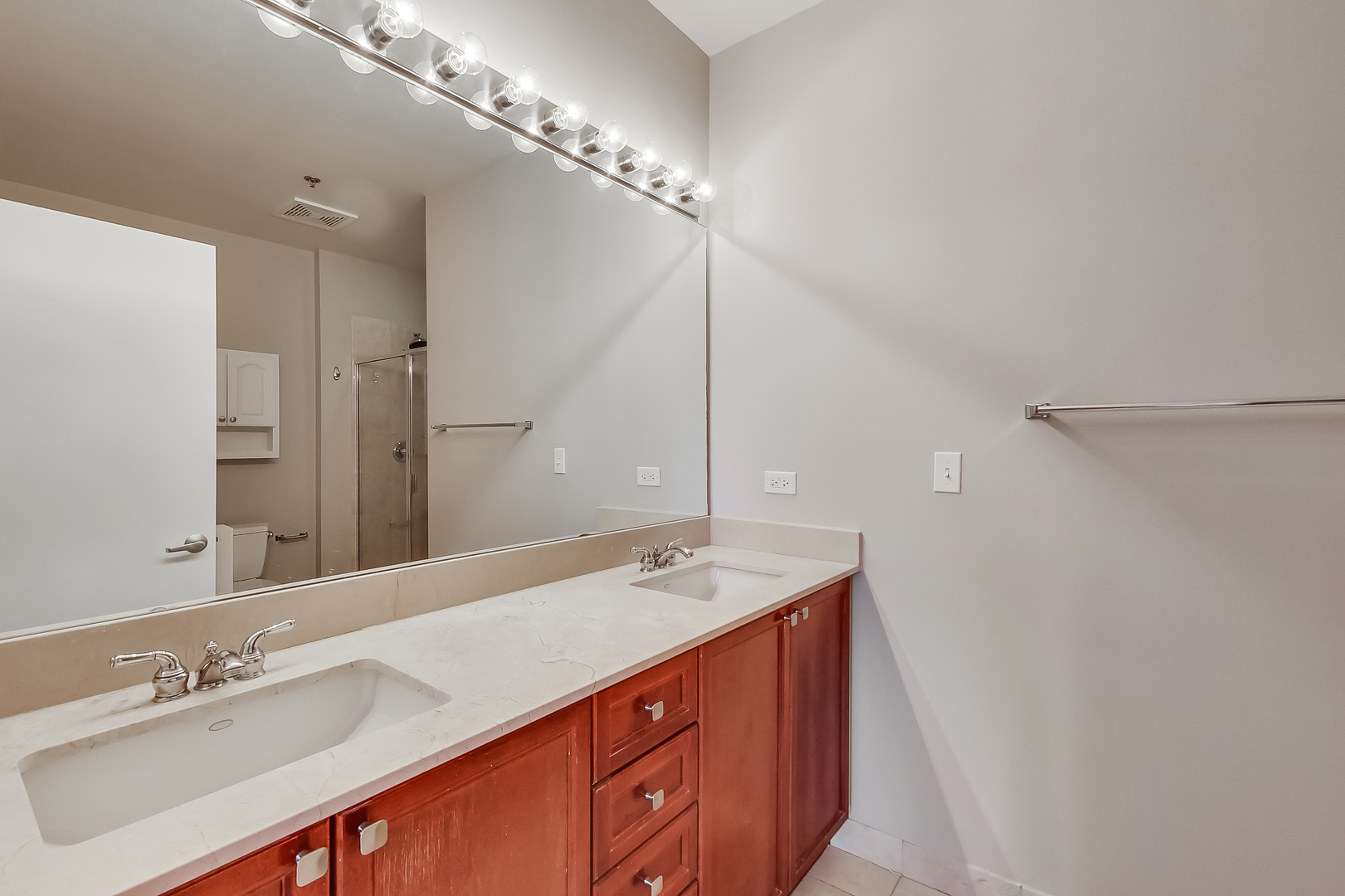 950 West Monroe Street, Unit 903 Chicago, IL 60607 - Photo 12 of 27 a spacious bathroom with a sink double vanity and a mirror