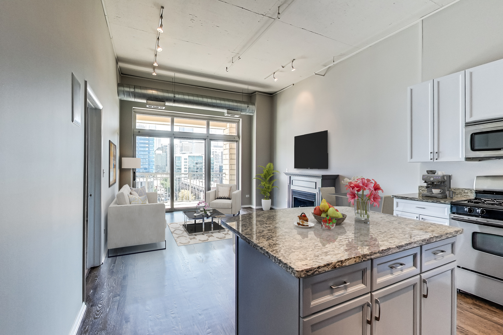 950 West Monroe Street, Unit 903 Chicago, IL 60607 - Photo 3 of 27 a kitchen with granite countertop a stove and white cabinets