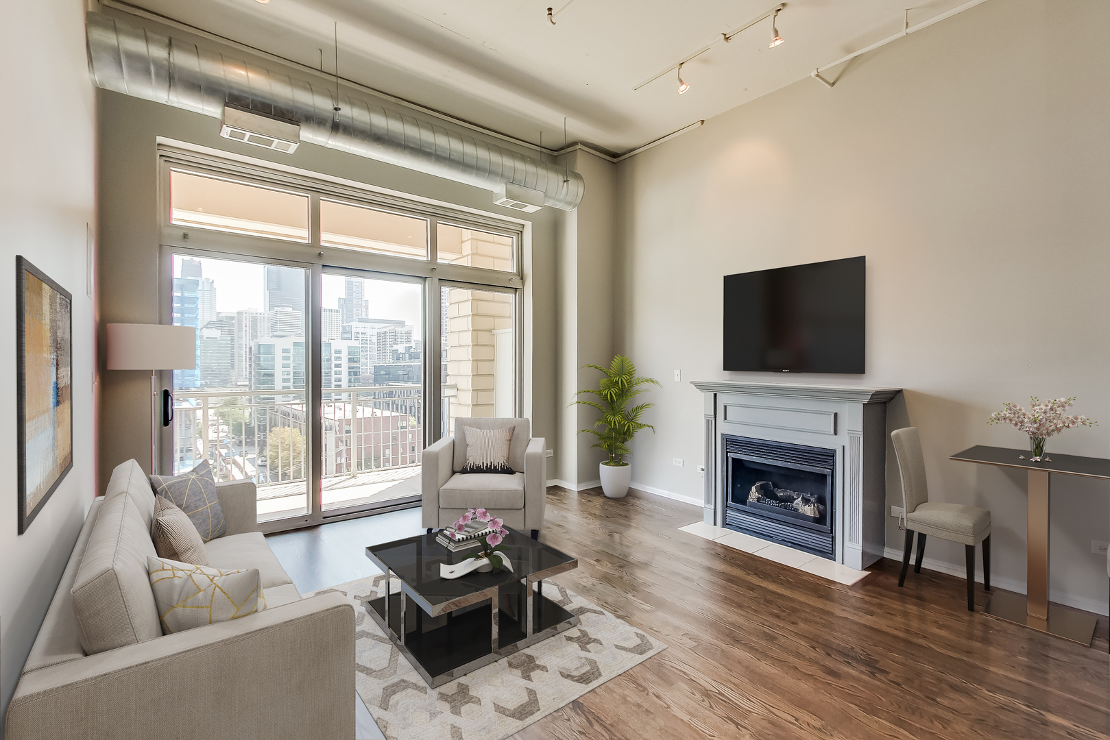 950 West Monroe Street, Unit 903 Chicago, IL 60607 - Photo 8 of 27 a living room with furniture a fireplace and a flat screen tv